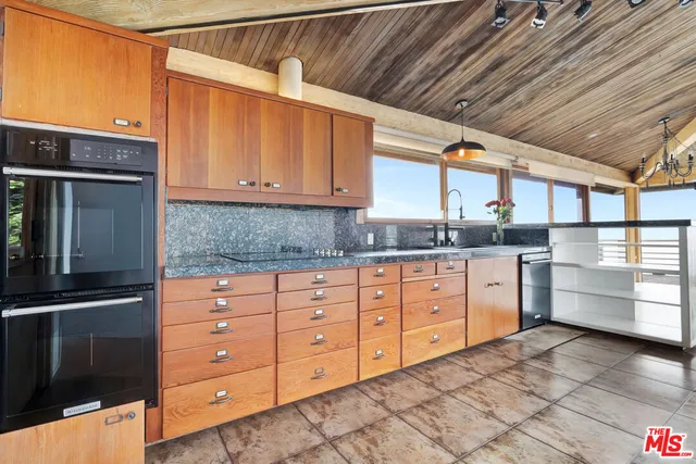 a view of a room with wooden floor and a window