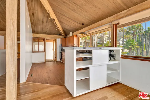 a view of a room with wooden floor