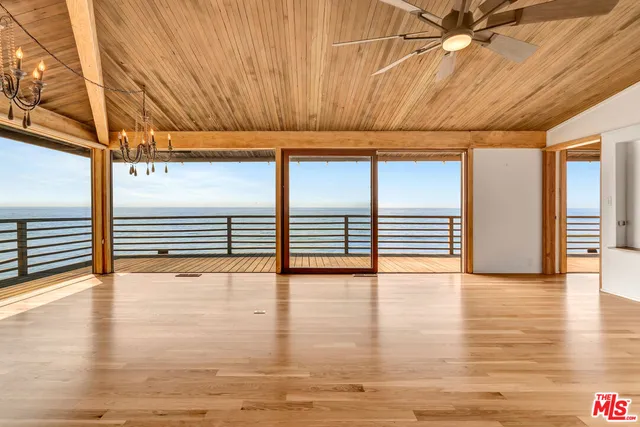 a backyard of a house with a garden and barbeque oven