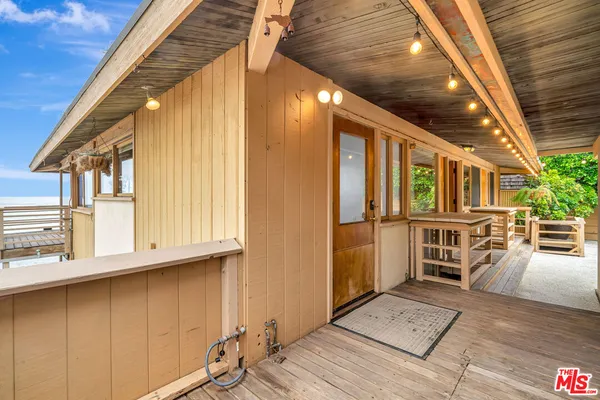 a view of a room with wooden floor and fireplace