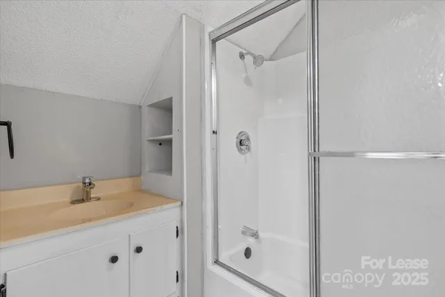 a bathroom with a tub and a sink