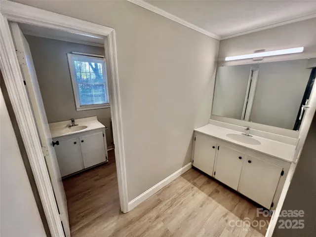 a bathroom with a double vanity sink and mirror