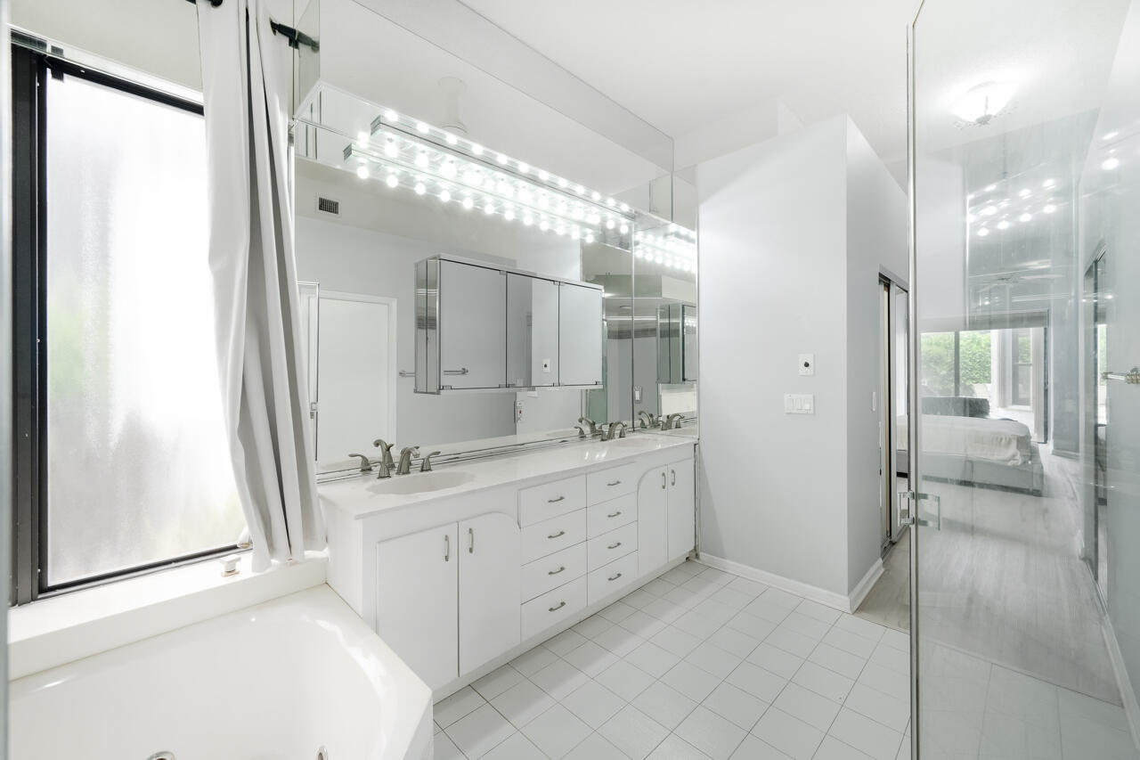 2412 Northwest 63rd Street Boca Raton, FL 33496 - Photo 23 of 53 a bathroom with a double vanity sink mirror and shower