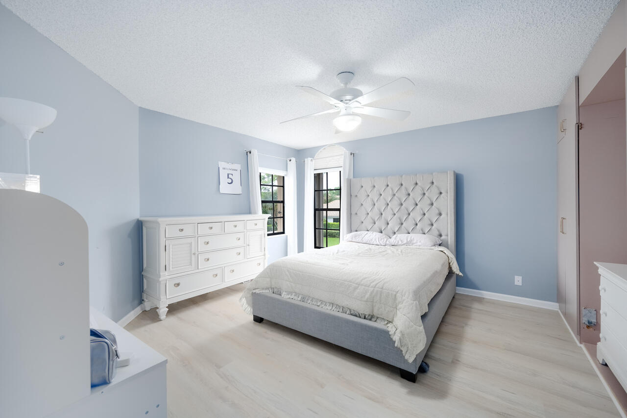 2412 Northwest 63rd Street Boca Raton, FL 33496 - Photo 33 of 53 a bedroom with a bed and a window