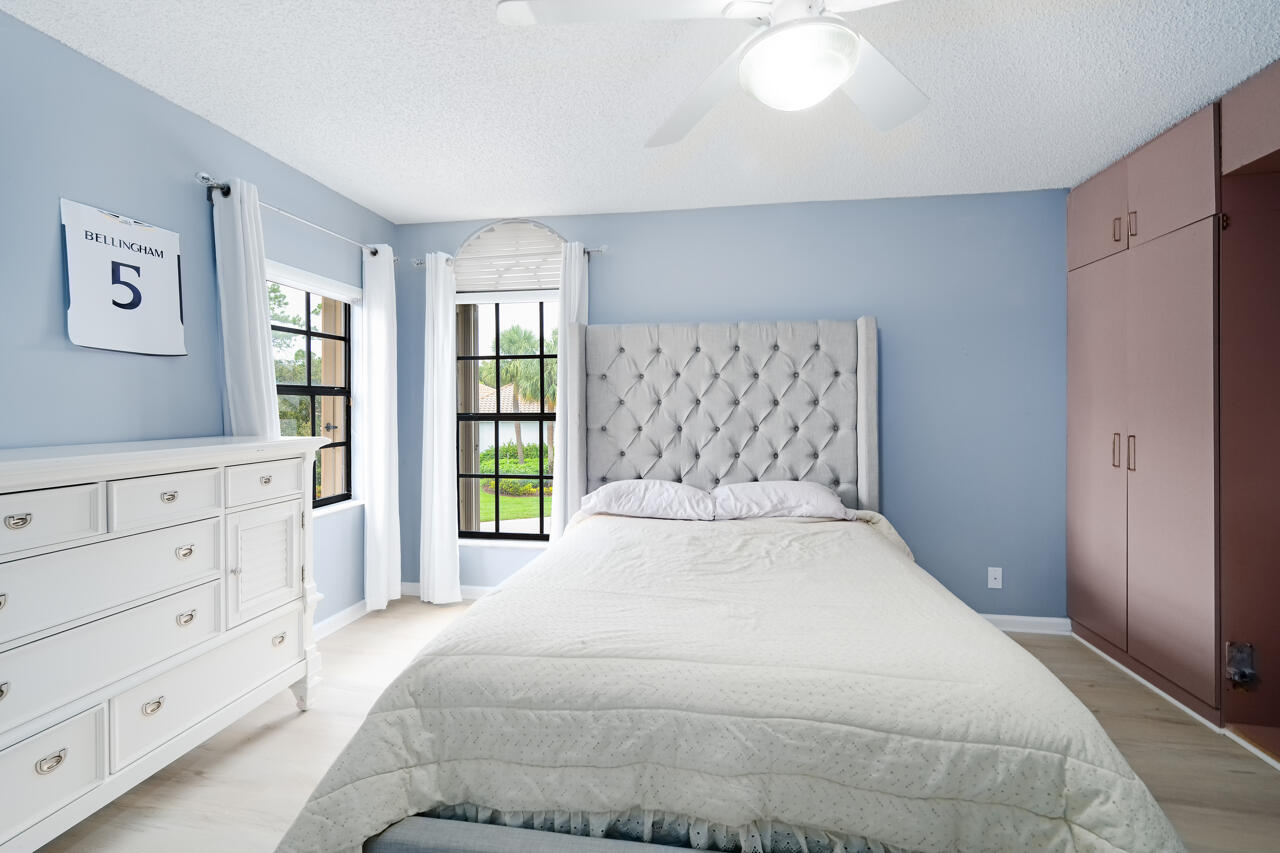 2412 Northwest 63rd Street Boca Raton, FL 33496 - Photo 34 of 53 a bedroom with a large bed and a window