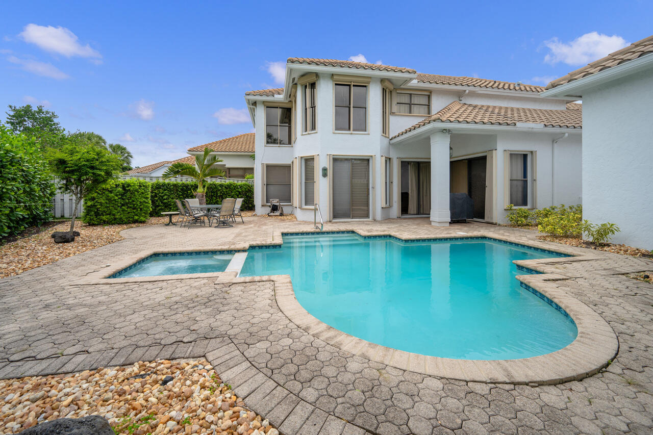 2412 Northwest 63rd Street Boca Raton, FL 33496 - Photo 40 of 53 a view of a white building with swimming pool in front of it