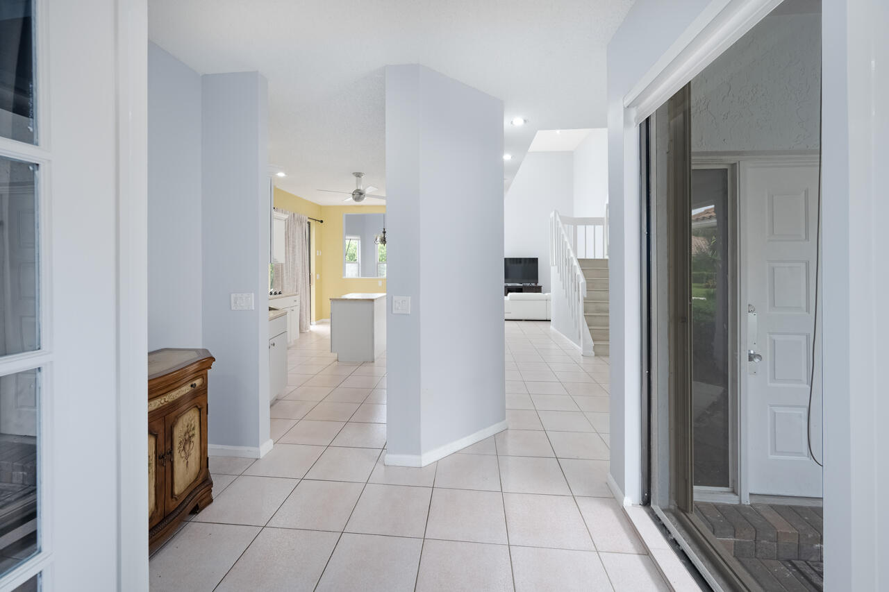 2412 Northwest 63rd Street Boca Raton, FL 33496 - Photo 6 of 53 a view of a hallway with wooden floor