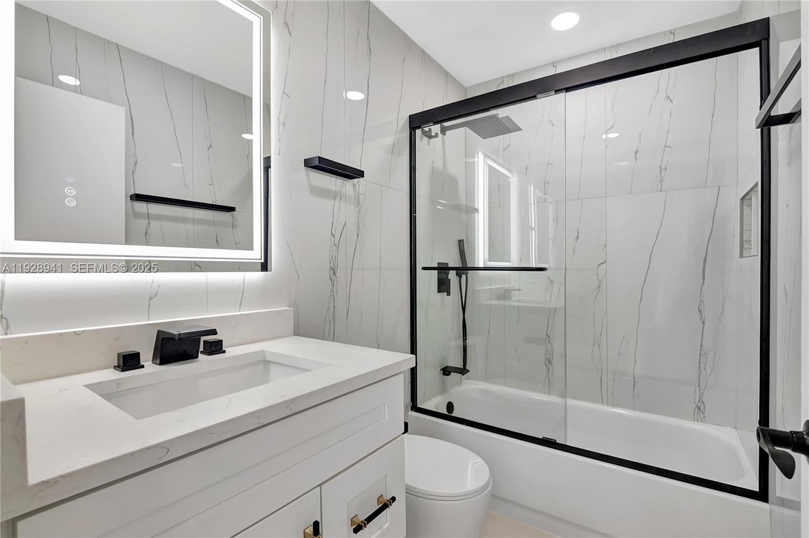 708 Normandy Lane, Unit 708 Delray Beach, FL 33484 - Photo 3 of 43 a bathroom with a sink toilet and shower
