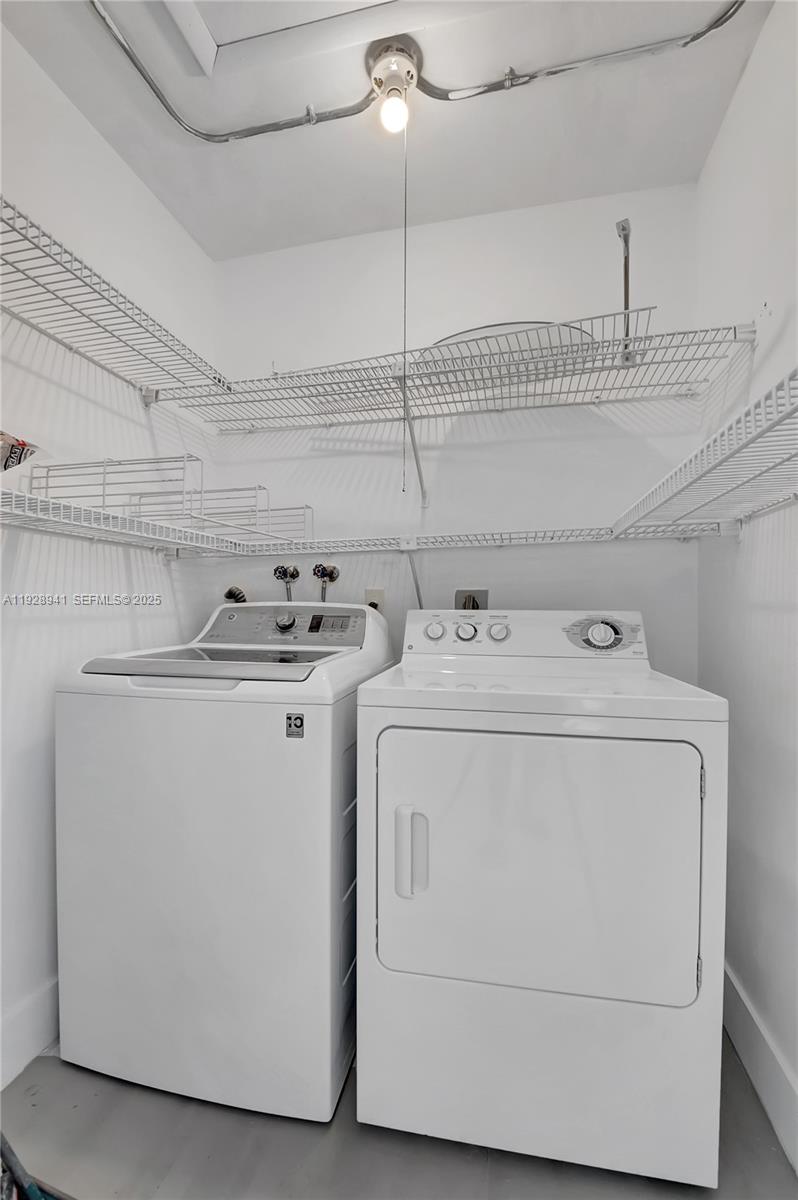 708 Normandy Lane, Unit 708 Delray Beach, FL 33484 - Photo 4 of 43 a utility room with dryer and washer