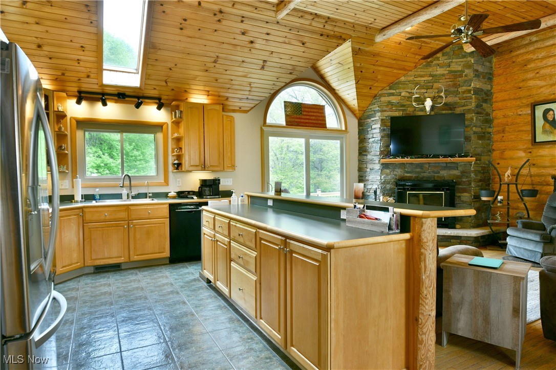2907 Bushnell Campbell Road Fowler, OH 44418 - Photo 12 of 49 Kitchen with wooden ceiling, freestanding refrigerator, black dishwasher, vaulted ceiling, and a sink