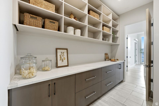 2002 East Outlaw Road Kamas, UT 84036 - Photo 60 of 65 Expansive pantry featuring extensive built-in shelving, a quartz countertop, and integrated base cabinetry