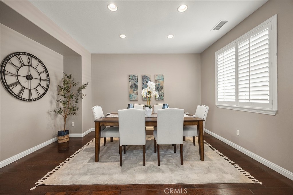 14280 Brant Court Eastvale, CA 92880 - Photo 11 of 47 a view of a dining room with furniture window and wooden floor