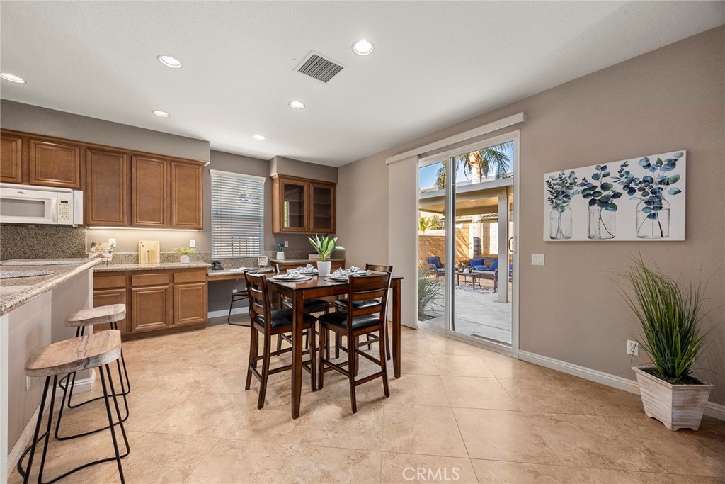 14280 Brant Court Eastvale, CA 92880 - Photo 16 of 47 a kitchen with a table and chairs in it