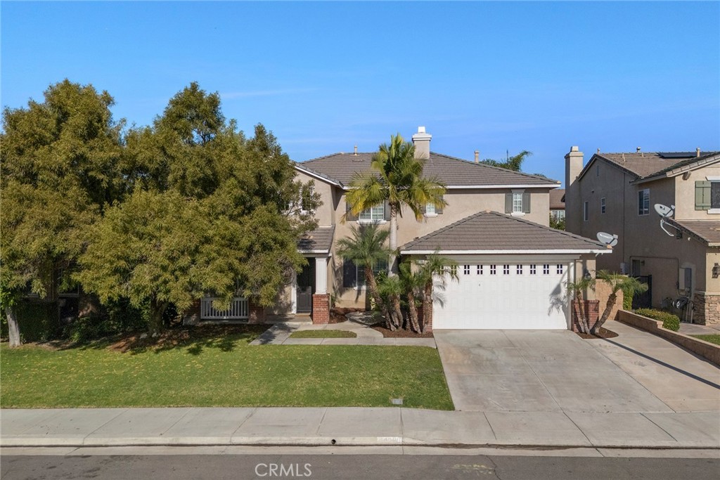 14280 Brant Court Eastvale, CA 92880 - Photo 2 of 47 a front view of a house with a yard