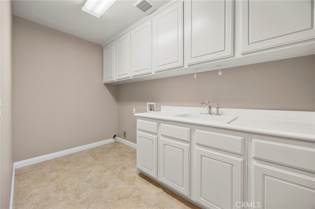 14280 Brant Court Eastvale, CA 92880 - Photo 25 of 47 a bathroom with a sink and cabinets