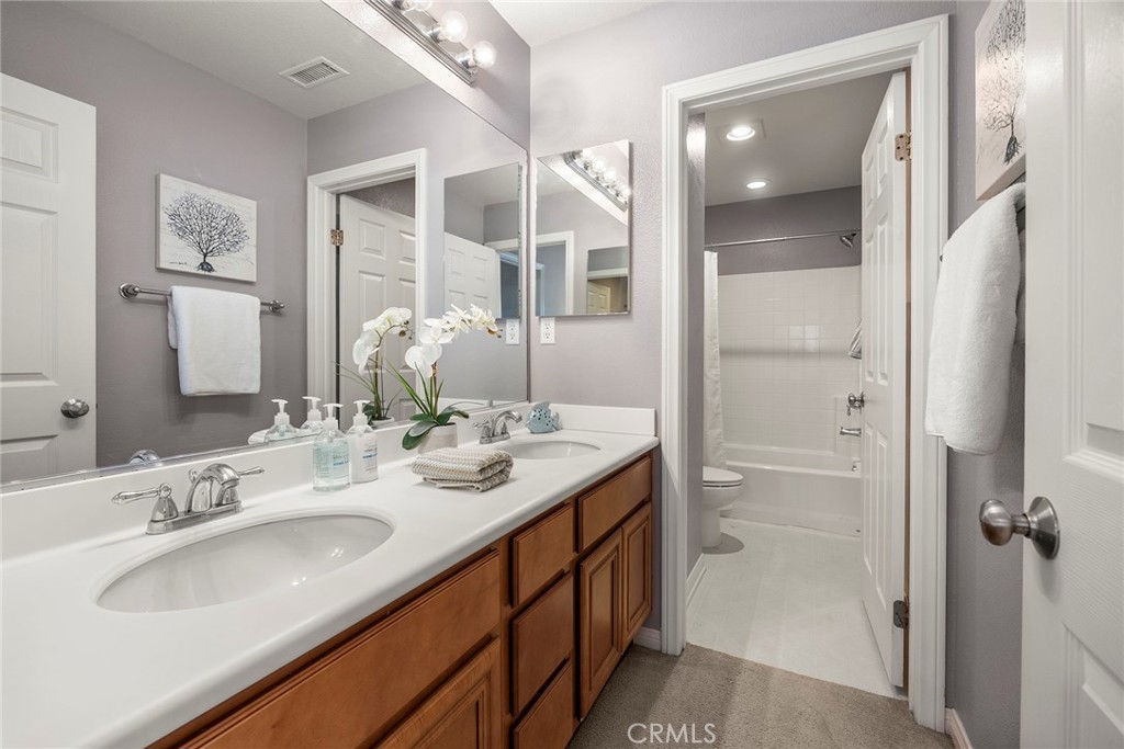 14280 Brant Court Eastvale, CA 92880 - Photo 29 of 47 a bathroom with a double vanity sink mirror and double