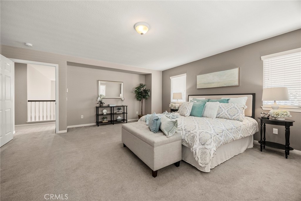 14280 Brant Court Eastvale, CA 92880 - Photo 32 of 47 a spacious bedroom with a bed and window