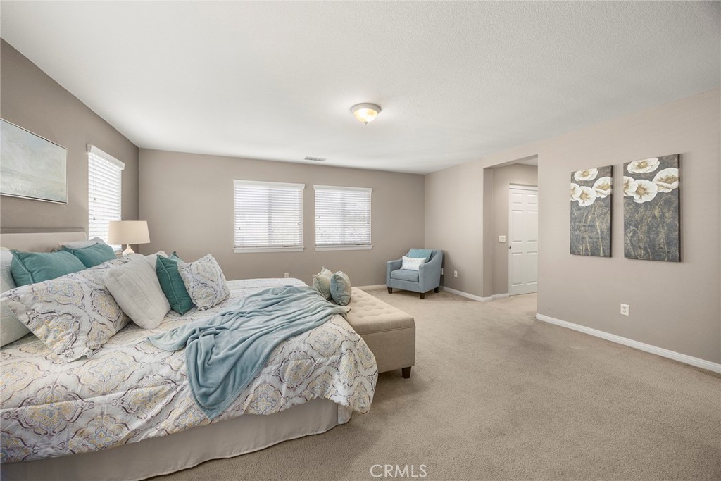 14280 Brant Court Eastvale, CA 92880 - Photo 37 of 47 a large white bed in a white room