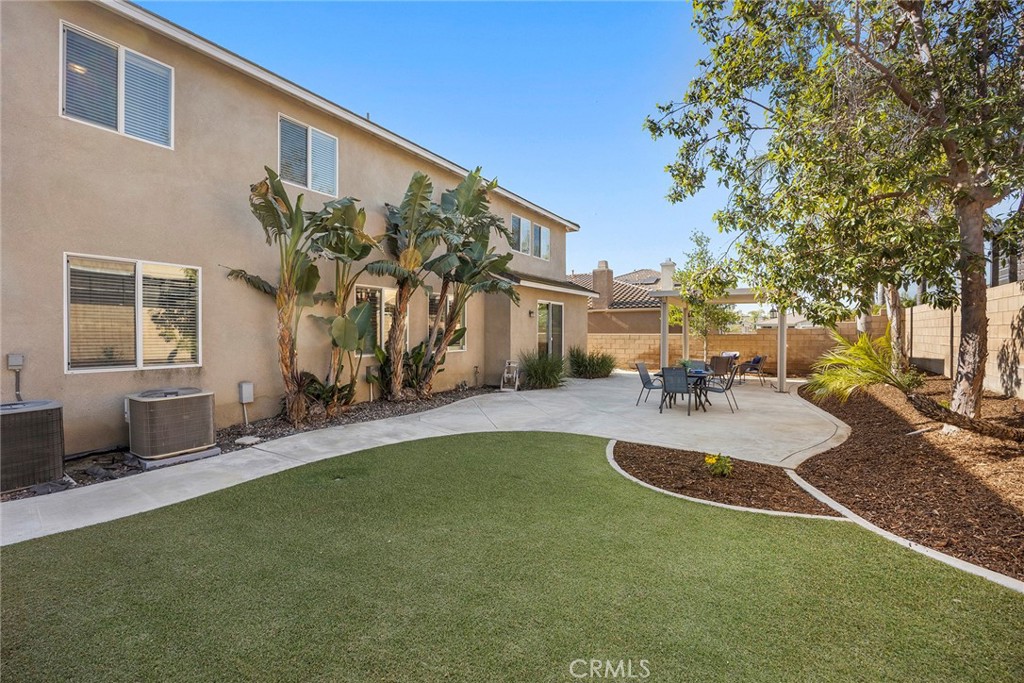 14280 Brant Court Eastvale, CA 92880 - Photo 44 of 47 a view of a backyard with a patio