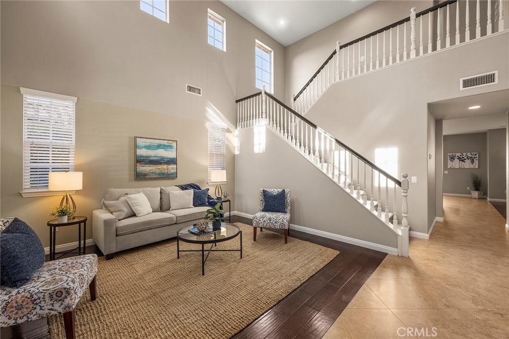 14280 Brant Court Eastvale, CA 92880 - Photo 8 of 47 a living room with furniture and a table with wooden floor