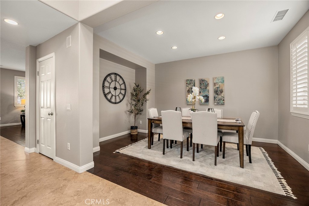 14280 Brant Court Eastvale, CA 92880 - Photo 10 of 47 a view of a dining room with furniture window and wooden floor