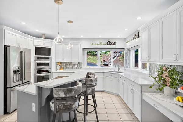 a kitchen with a stove a sink and a refrigerator