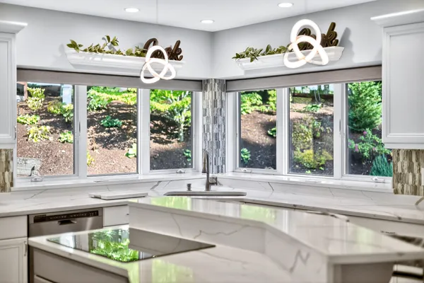 a kitchen with a sink stainless steel appliances and white cabinets