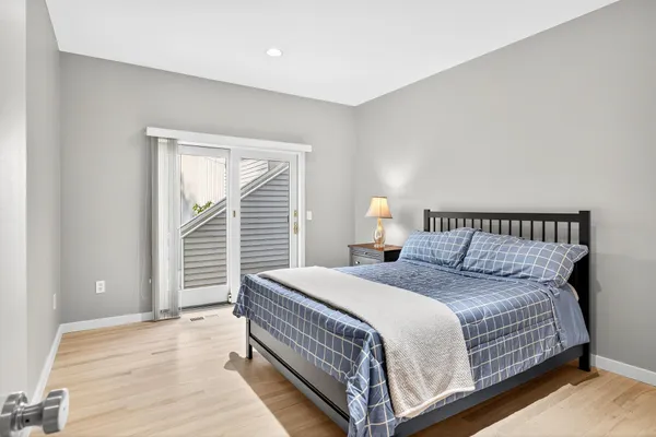 a bedroom with a bed and a painting