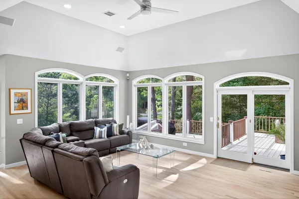 a living room with furniture and large windows