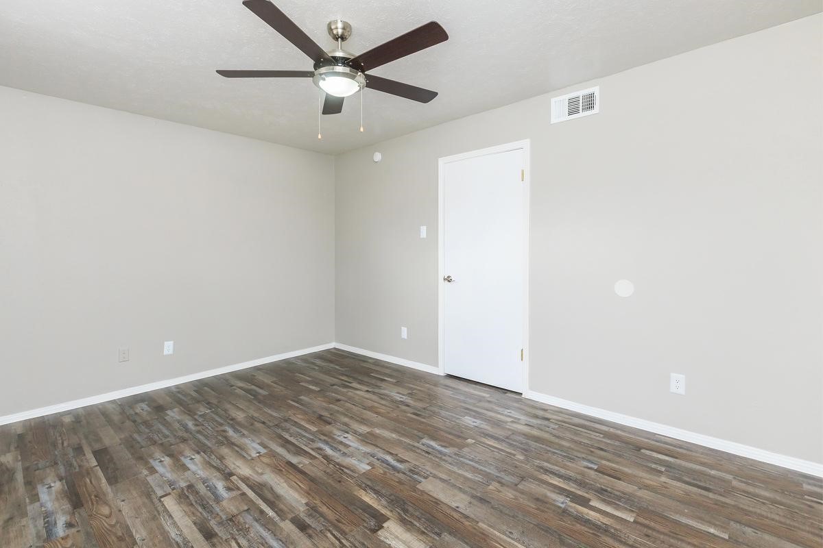 1212 Hampshire Lane, Unit 2111 Richardson, TX 75080 - Photo 25 of 40 an empty room with wooden floor and windows