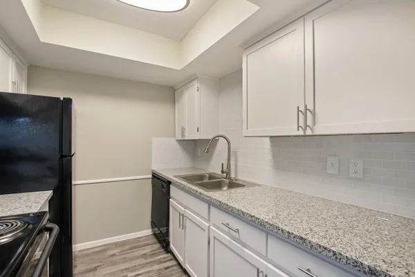 a kitchen with stainless steel appliances granite countertop a stove and a refrigerator