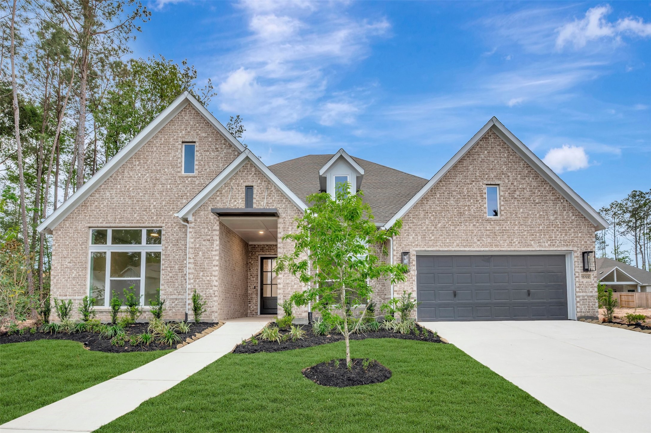 15722 Terracotta Terrace Conroe, TX 77302 - Photo 2 of 50 a front view of a house with a yard and garage