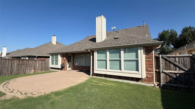 a front view of a house with a garden and yard