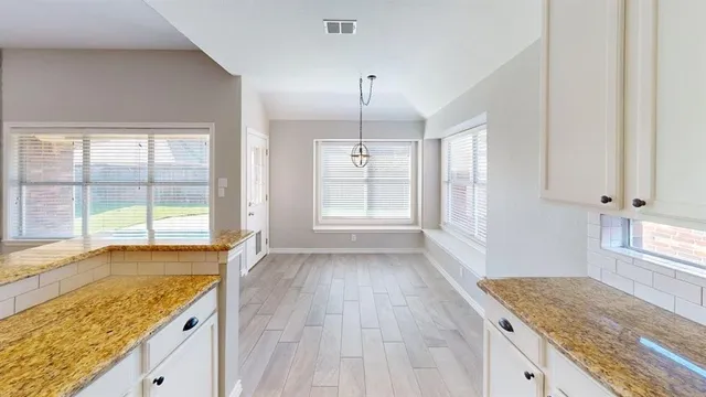 a view of a kitchen cabinets and wooden floor