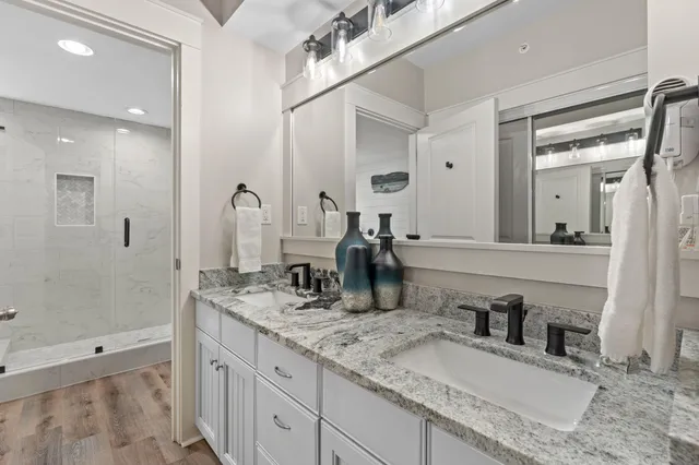a bathroom with double vanity sinks and a mirror