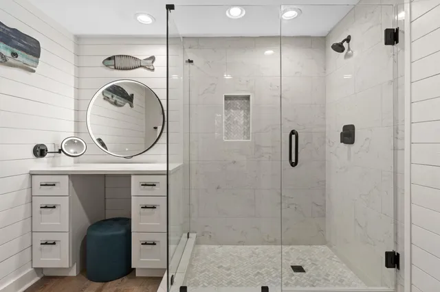 a bathroom with a sink a vanity and shower