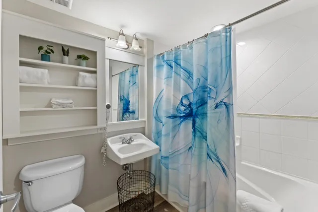 a bathroom with a toilet a sink and bathtub