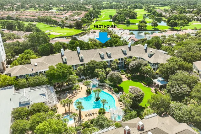 an aerial view of residential houses with outdoor space and street view