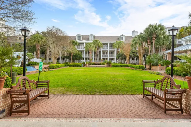a view of a park with couches and table and chairs and garden