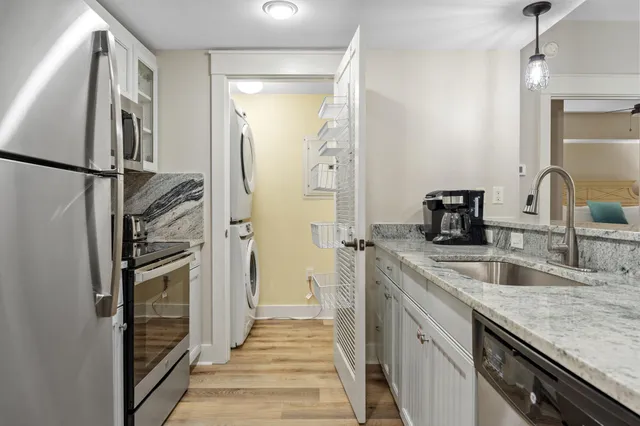 a kitchen with a sink and a refrigerator