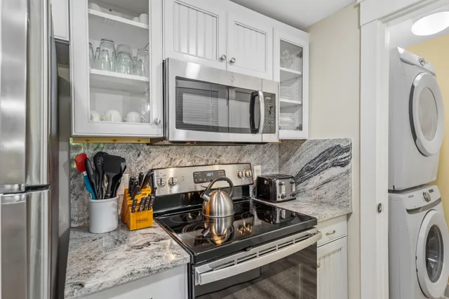 a kitchen with granite countertop a stove and a refrigerator