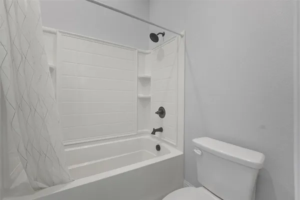 a bathroom with a toilet and a bathtub