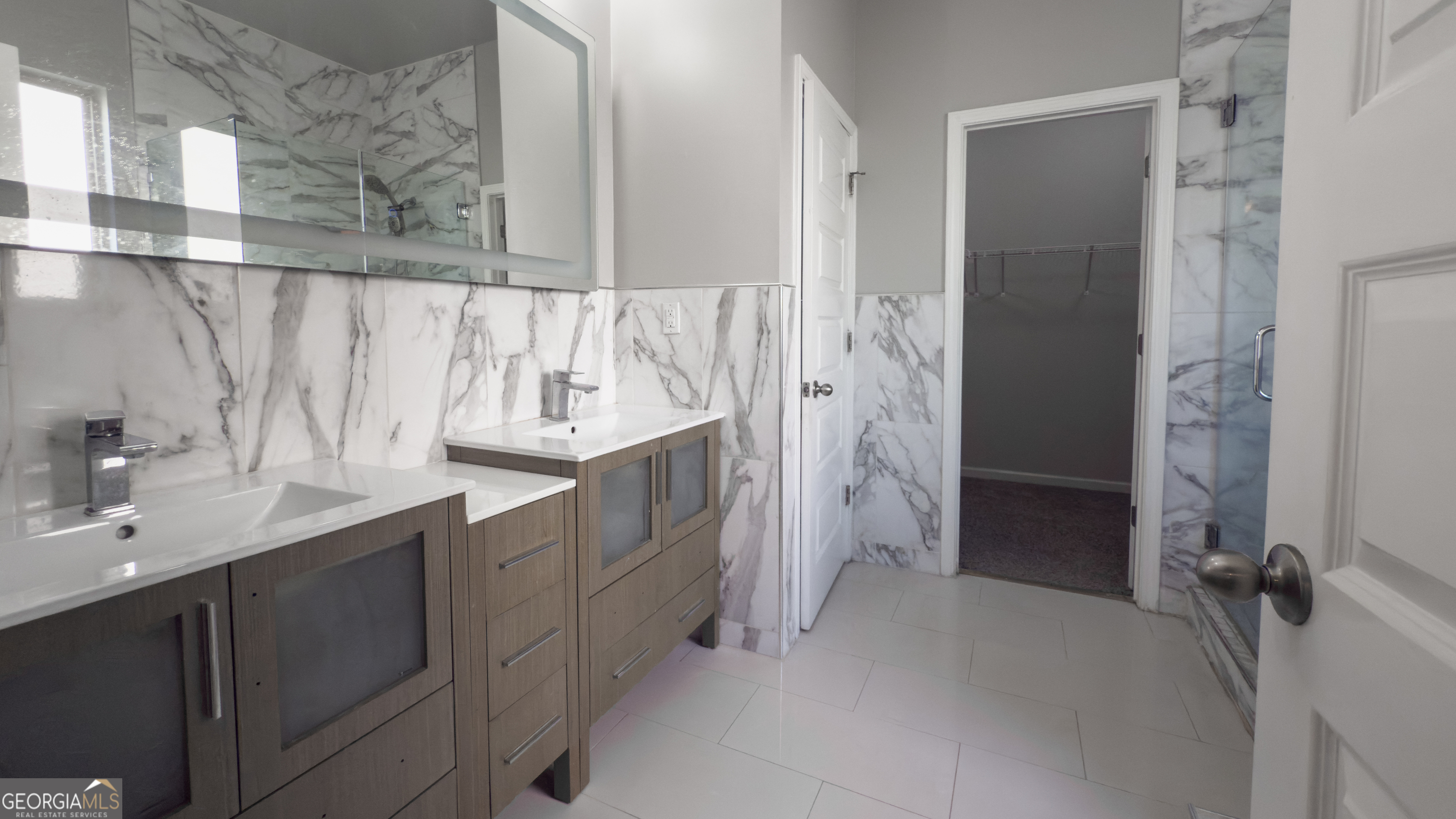 3368 Alhambra Circle Hampton, GA 30228 - Photo 15 of 43 a bathroom with a double vanity sink mirror and shower