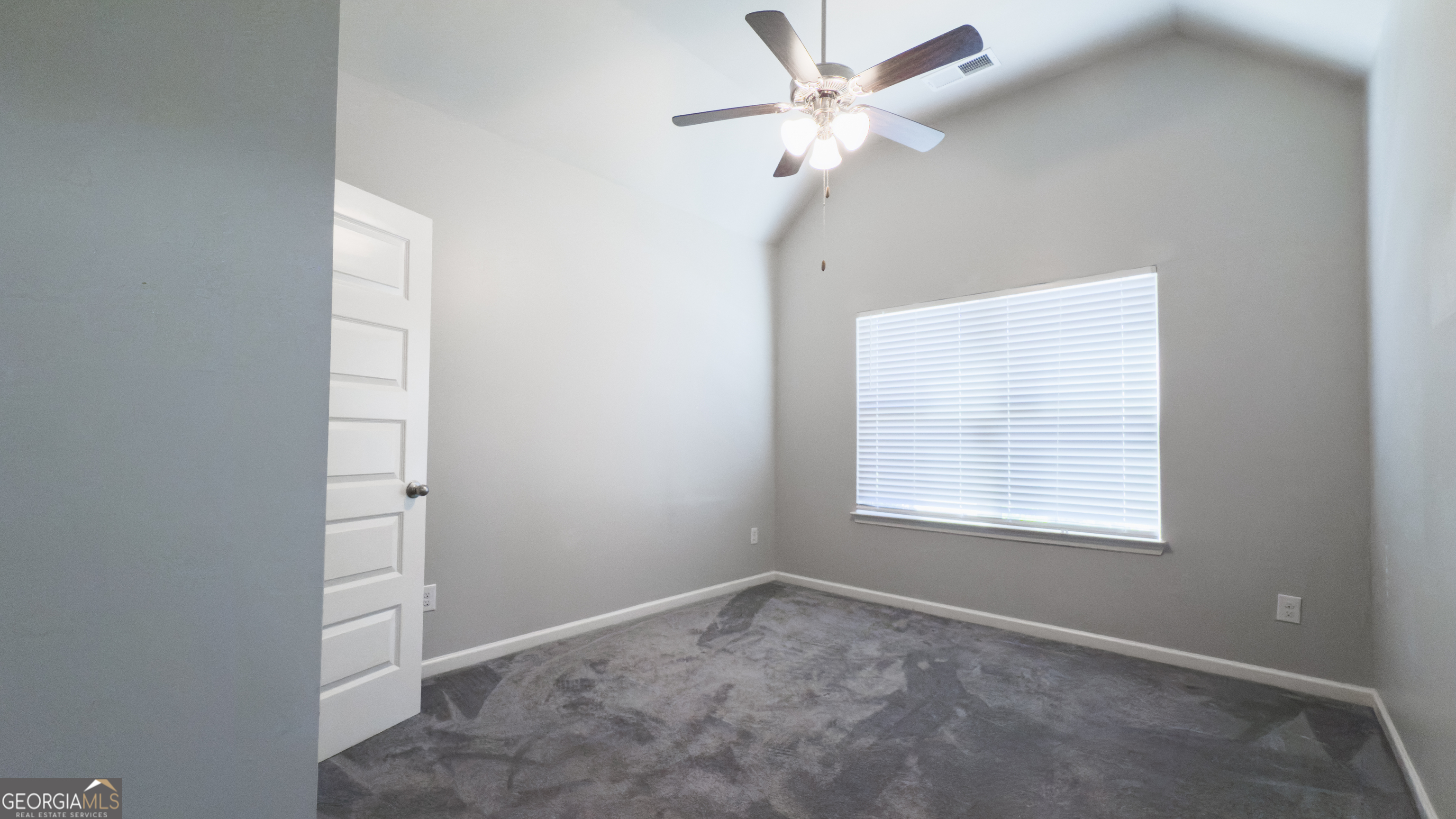 3368 Alhambra Circle Hampton, GA 30228 - Photo 23 of 43 an empty room with windows and fan