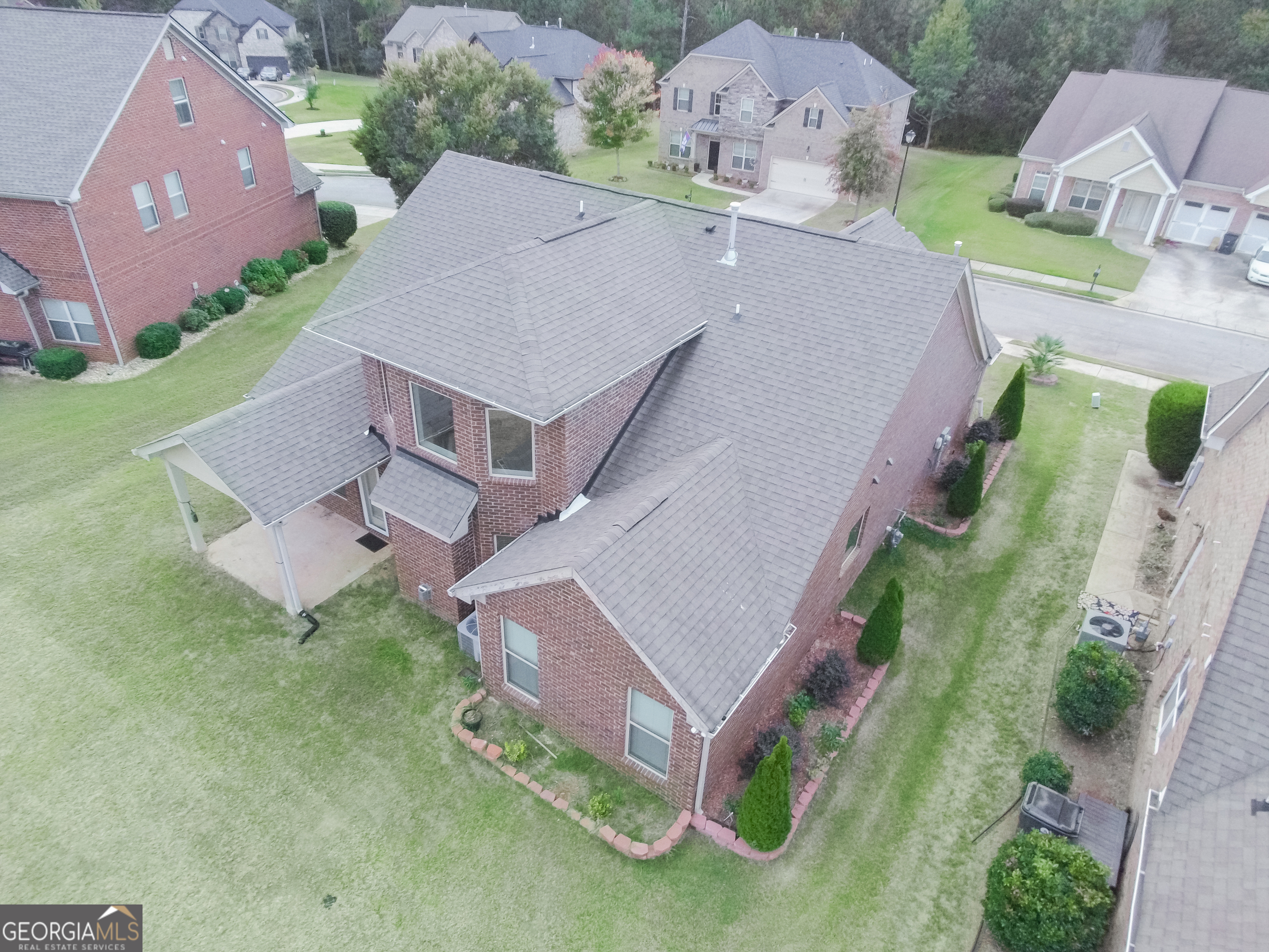 3368 Alhambra Circle Hampton, GA 30228 - Photo 4 of 43 an aerial view of a house with a garden and plants