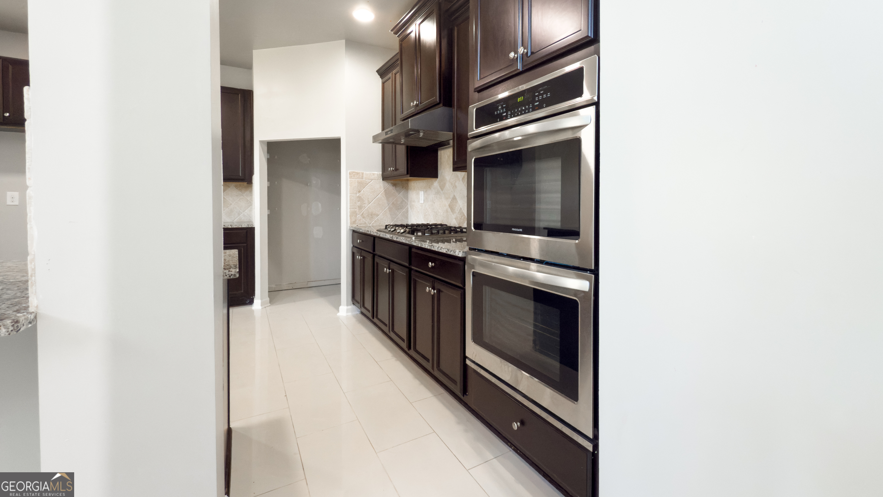 3368 Alhambra Circle Hampton, GA 30228 - Photo 8 of 43 a kitchen with stainless steel appliances granite countertop a stove and a refrigerator