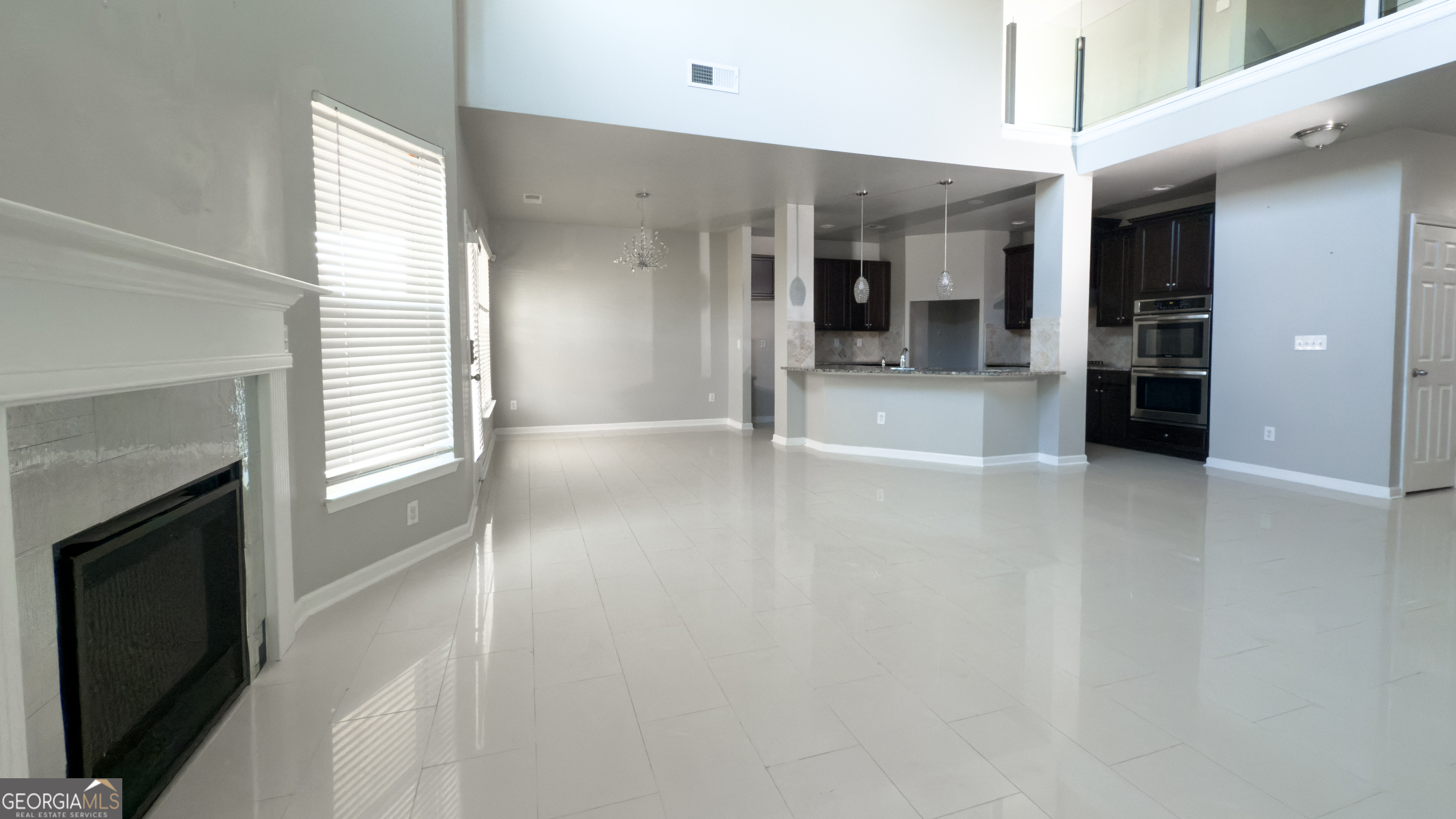 3368 Alhambra Circle Hampton, GA 30228 - Photo 10 of 43 a view of a hallway with wooden floor and a fireplace