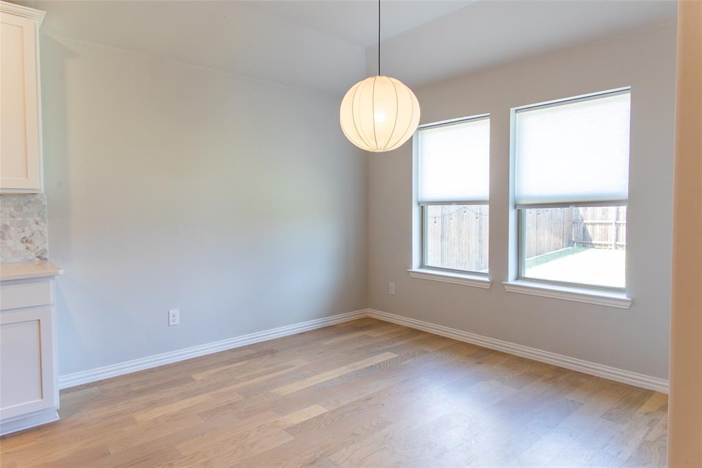 2604 Freeman Street Anna, TX 75409 - Photo 15 of 18 an empty room with wooden floor and windows