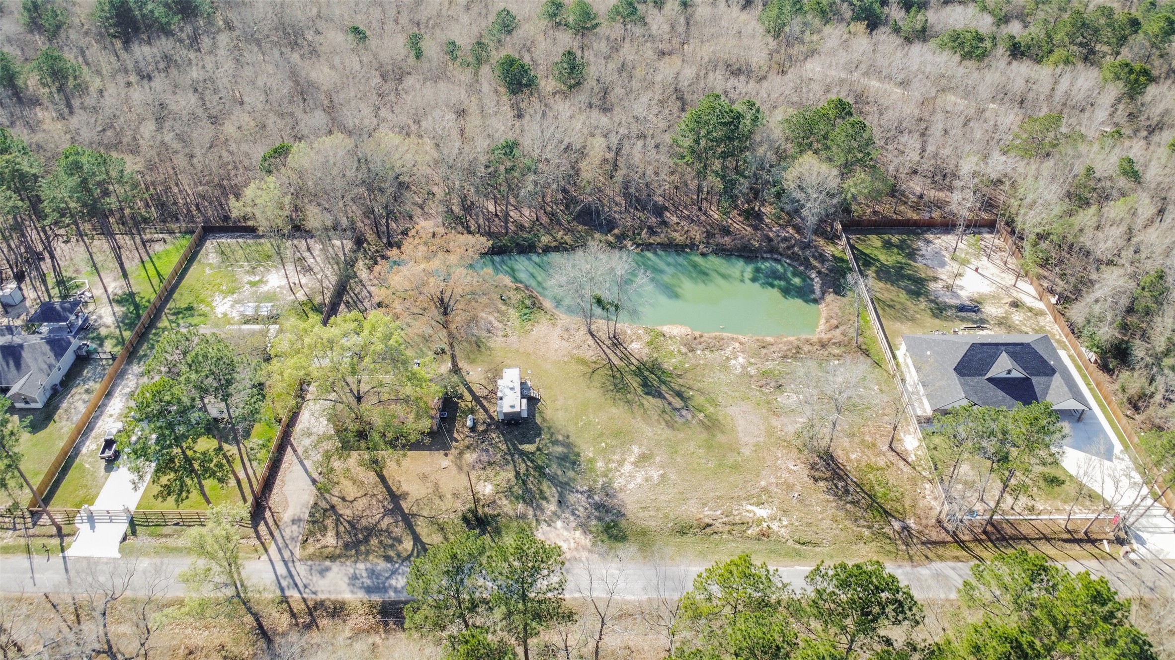 257 County Road 3669B Splendora, TX 77372 - Photo 2 of 14 a view of a yard with plants and large trees