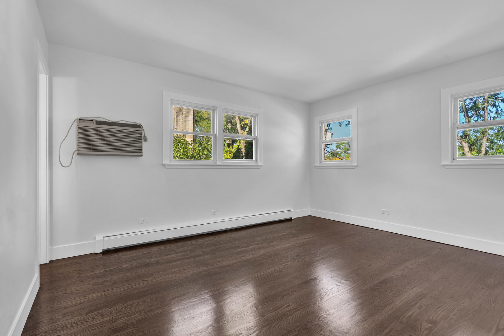 512 Ida Court, Unit 1 Mount Prospect, IL 60056 - Photo 11 of 22 a view of an empty room with window and wooden floor